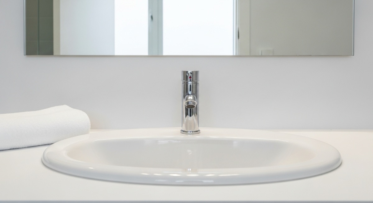 Bathroom after cleaning — spotless tile, mirrors, and fixtures